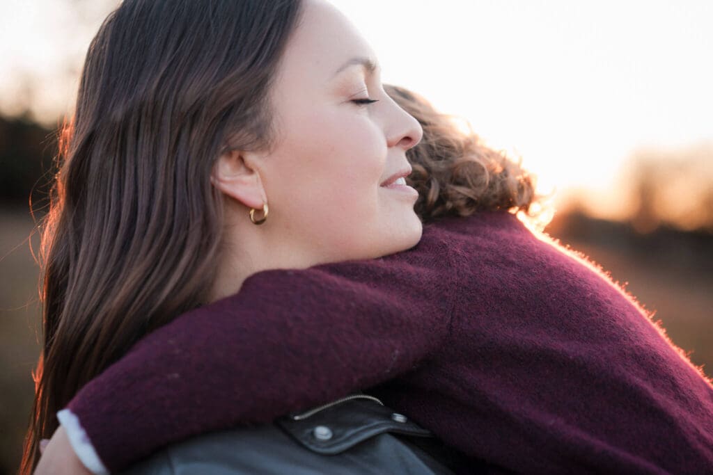 Mother holding young child outdoors during winter family photoshoot at Riemersee in Munich