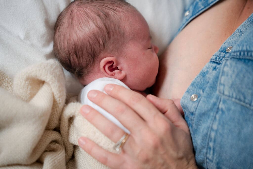 Baby sleeps peacefully next to mother