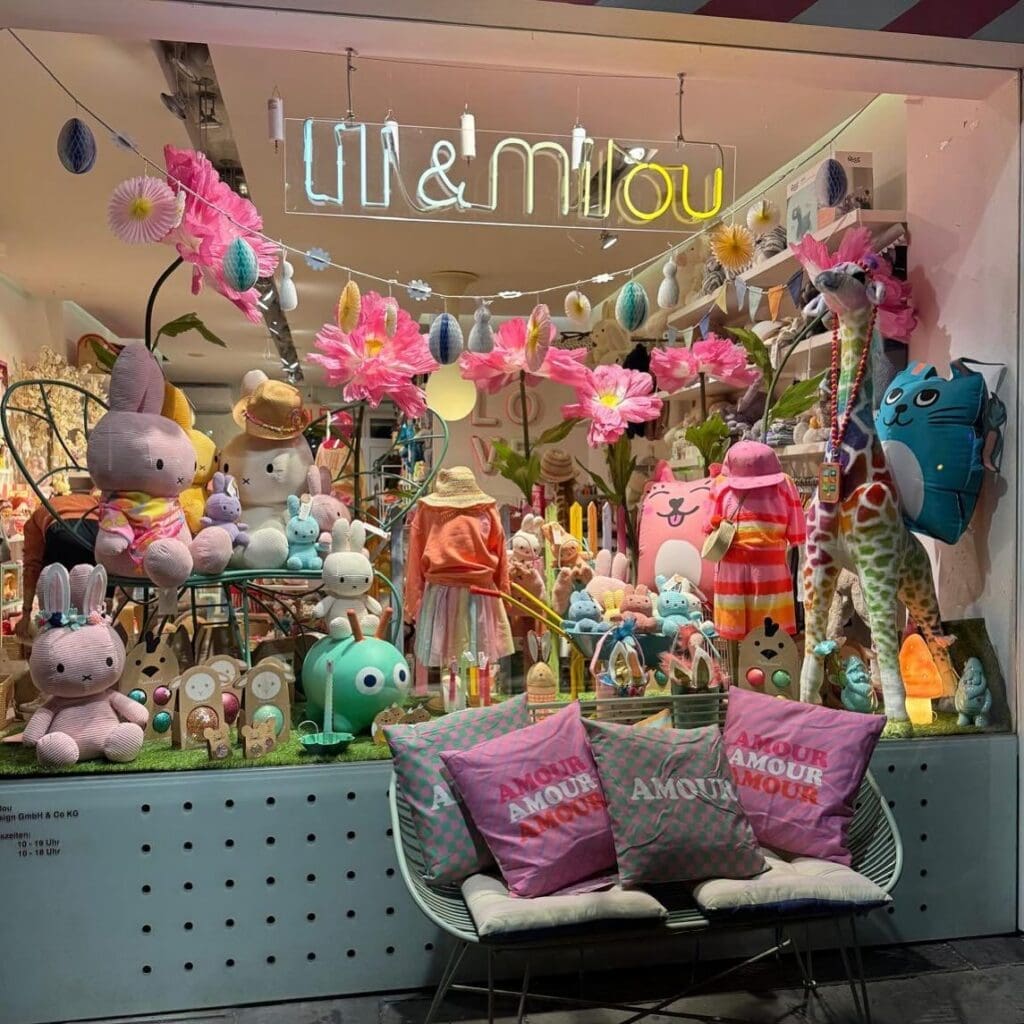 Outdoor storefront display with colorful kids clothing and toys of Lili & Milou children's boutique in Munich 