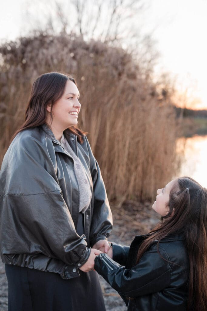 Mother and daughter laughing together during relaxed family photoshoot